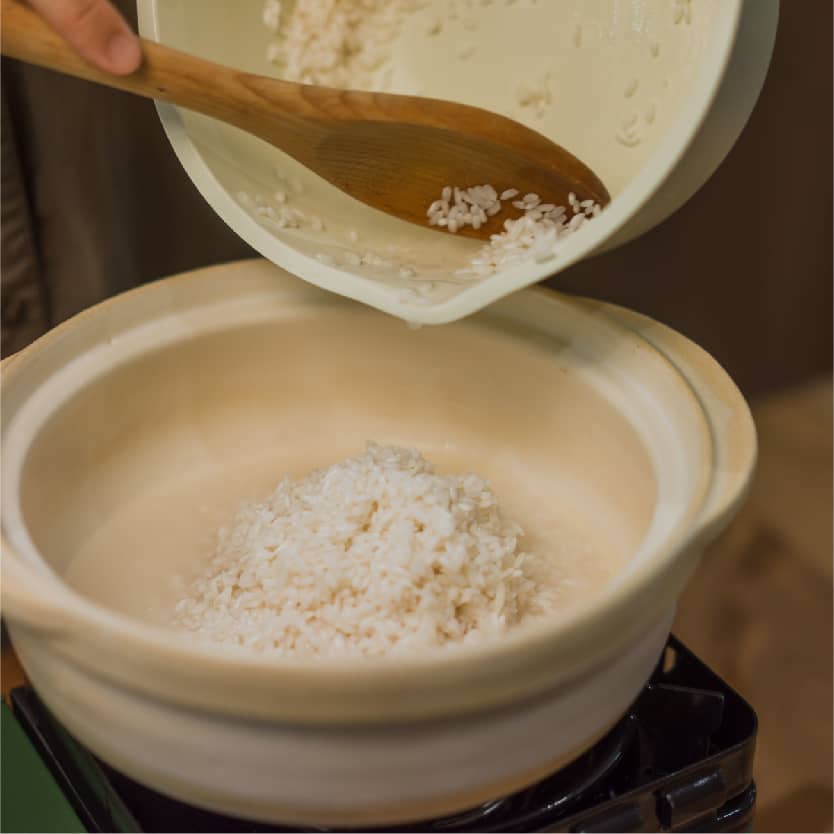 砂鍋內抹上沙拉油，倒入泡好的糯米，水滾後大火煮約3分鐘；開蓋後將米飯攪拌均勻後，放上蒸好的肝腸臘腸，蓋上鍋蓋小火煮10分鐘，再接著關火燜10分鐘。