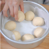 麵團取約25g備用，剩餘麵團分成7等分後滾圓；於8吋圓形模具中平均放置麵團成一圈。